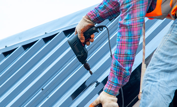 roofer metal roof installation with exposed fastener