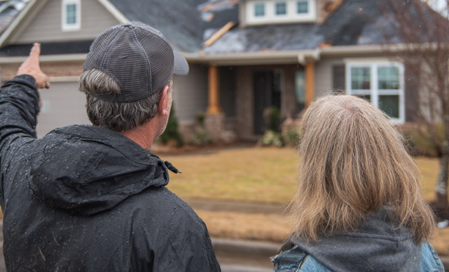 professional roofing contractor discussing repair options with a homeowner